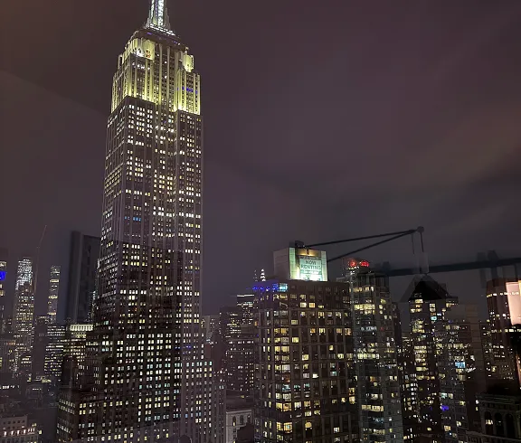 The Empire State Building lit up at night.